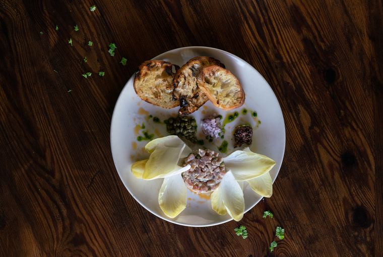 Chopped raw bigeye tuna plated with endive leaves